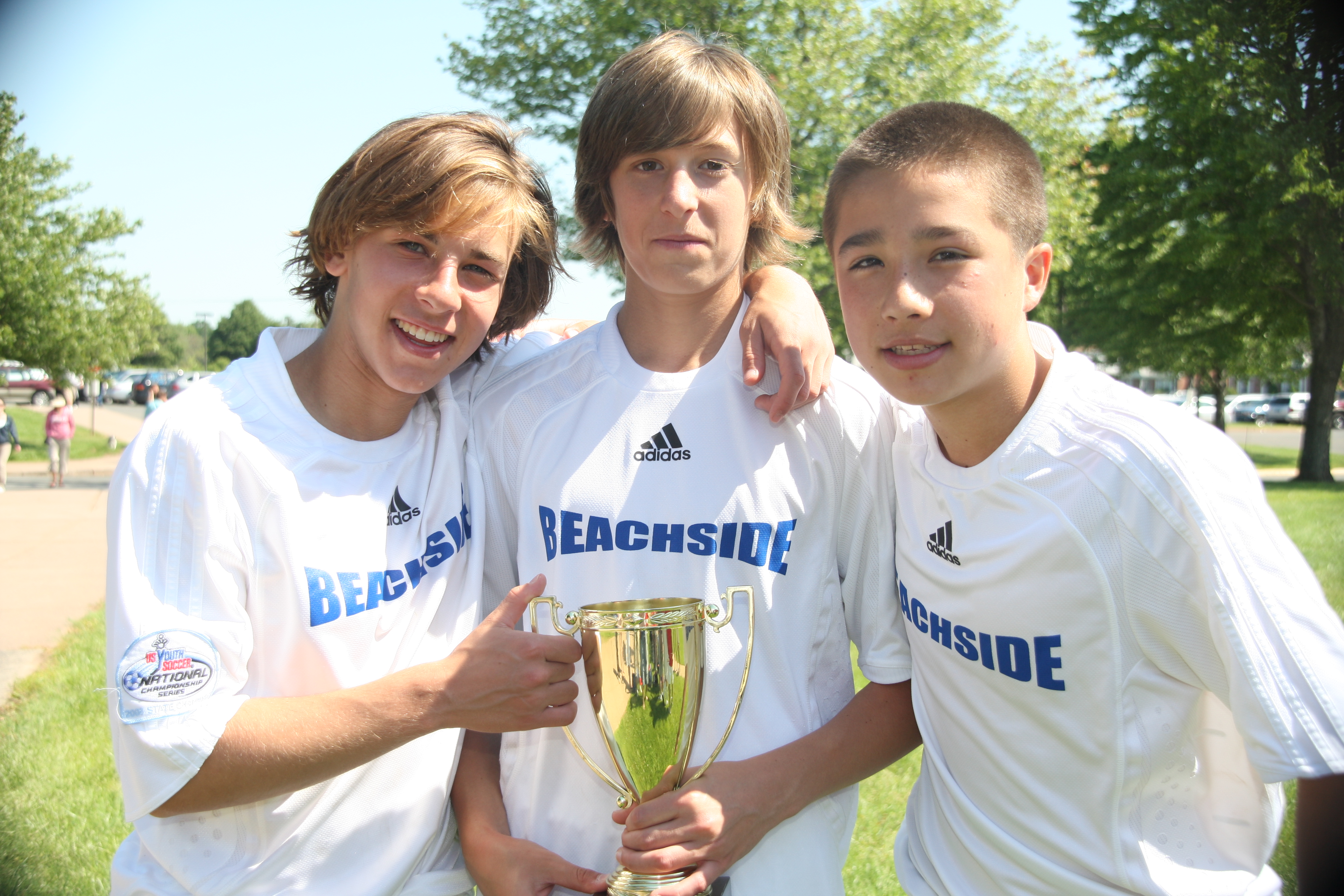 Jake Malowitz, Taylor McNair and Aaron Liu with their Beachside team's 2nd straight state trophy