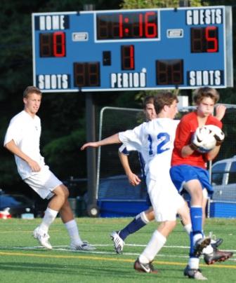 James Hickok saves in traffic iin the waning moments against Darien.  (Photo by Lisa Krosse)